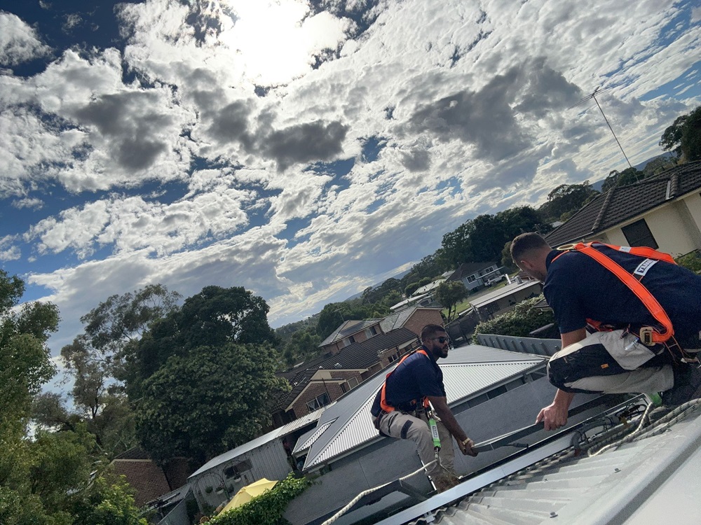 our technicians installing solar panel on a client's roof